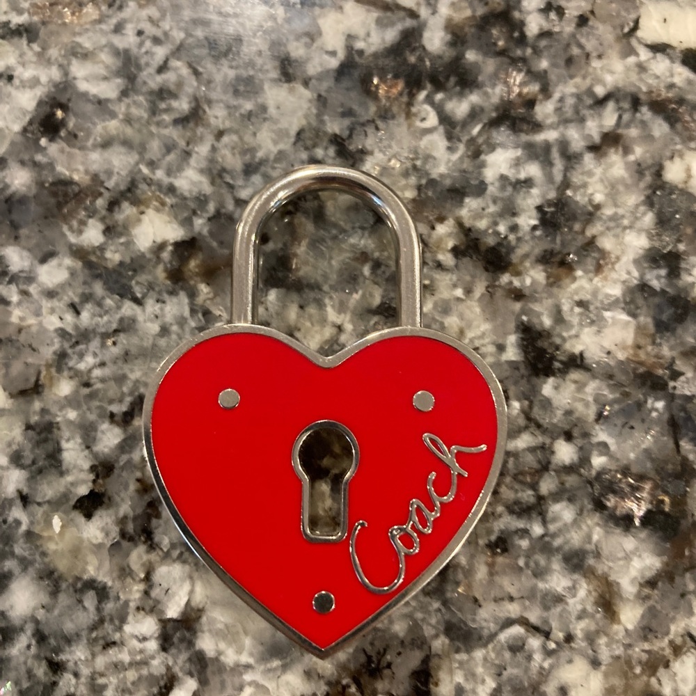 Coach heart lock keychain charm.